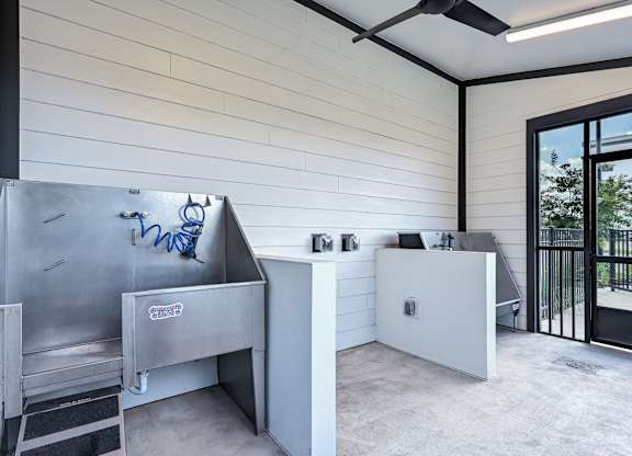A modern kitchen with a stainless steel sink and a white countertop at Ironwood Flats Apartments, Brandon, Florida