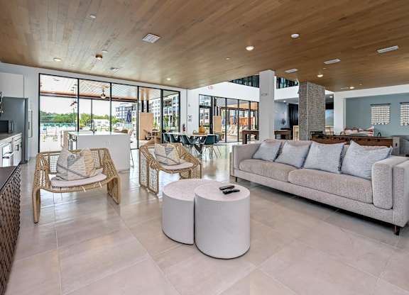 A modern living room with a wooden ceiling and a large window at Ironwood Flats Apartments, Brandon, FL