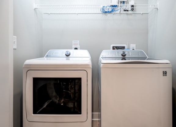 a washer and dryer sit next to each other in a laundry room at Ironwood Flats, Florida