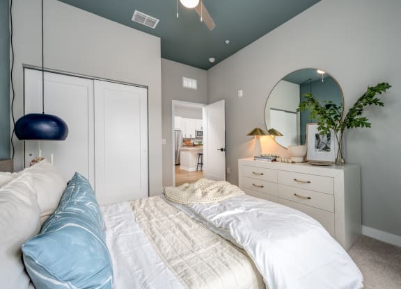 a bedroom with a bed and a dresser with a mirrorat Ironwood Flats, Brandon, FL, 33511