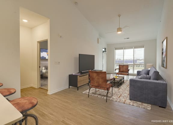 a living room with hardwood flooring and a flat screen tv  at Uptown Square Apartments, Michigan