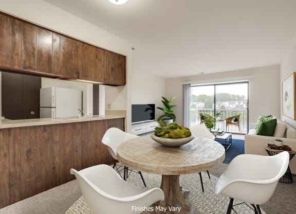 a kitchen and dining area in a 555 waverly unit  at The Landings Apartments, Westland, MI