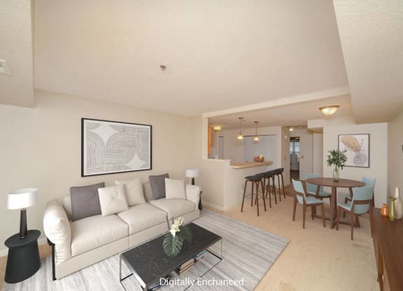 a living room and dining room with a couch and a table at Limestone Creek Apartment Homes, Madison, AL