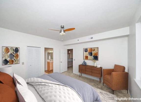 bedroom with a bed and a ceiling fan with attached bathroom at Limestone Creek Apartment Homes, Madison, AL