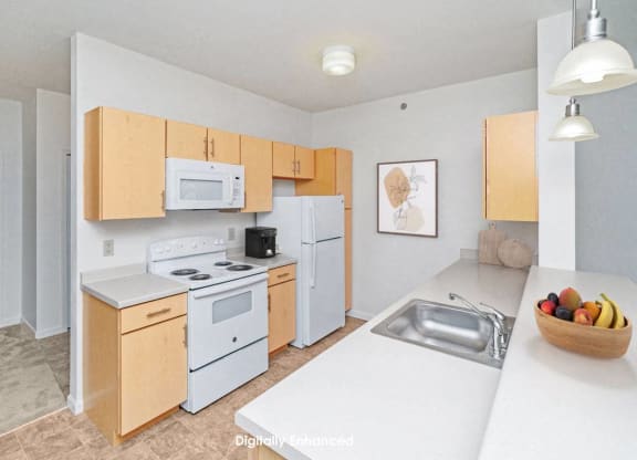 a two bedroom kitchen with white appliances and wooden cabinets at Limestone Creek Apartment Homes, Madison, AL
