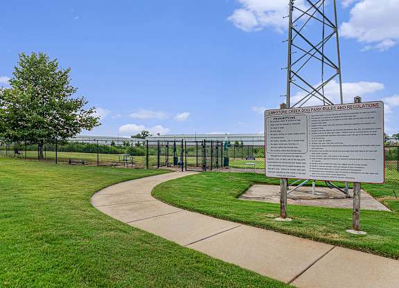 A dog park with a sign at Limestone Creek Apartment Homes, Madison, AL