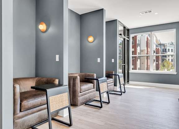 A row of brown leather chairs are lined up in a hallway at Luxe 360 on Centerpointe Apartments, Virginia, 23114