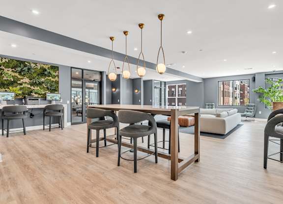 A modern dining room with a wooden table and chairs at Luxe 360 on Centerpointe Apartments, Midlothian, 23114