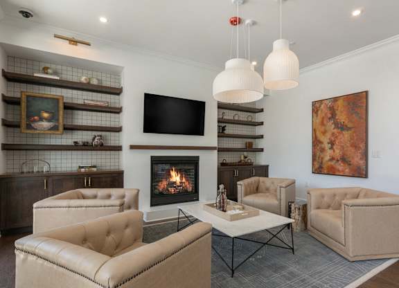 A living room with a fireplace and a painting on the wall at Luxe 360 on Centerpointe Apartments, Midlothian, 23114