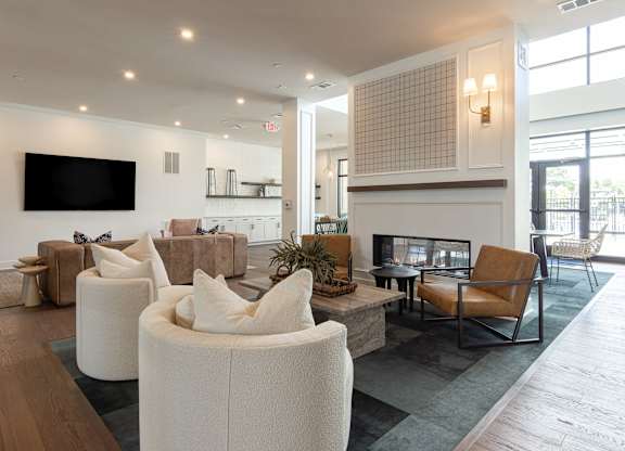 A modern living room with a flat screen TV mounted on the wall at Luxe 360 on Centerpointe Apartments, Virginia, 23114