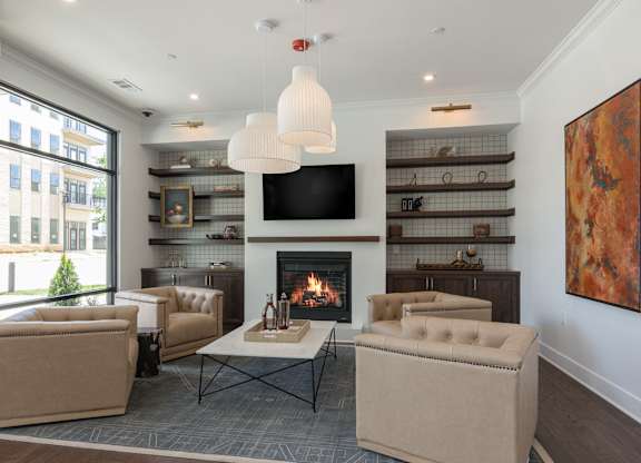 A living room with a fireplace and a television at Luxe 360 on Centerpointe Apartments, Midlothian, Virginia