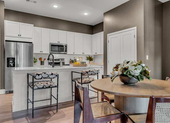 A kitchen with a table and chairs at Luxe 360 on Centerpointe Apartments, Midlothian, VA, 23114