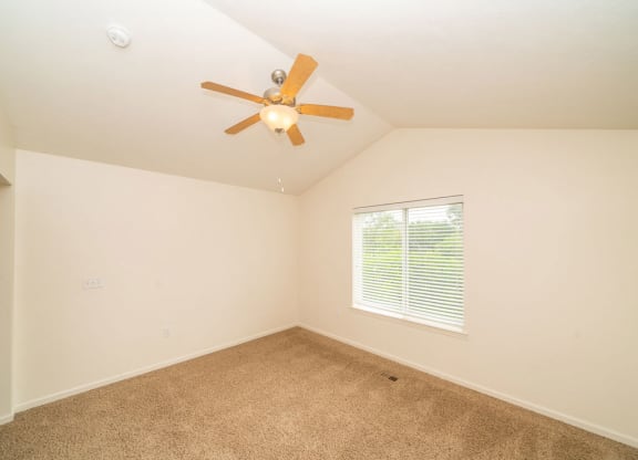 A bedroom with a cathedral ceiling and ceiling fan at Lynbrook Apartment Homes and Townhomes, Nebraska, 68022