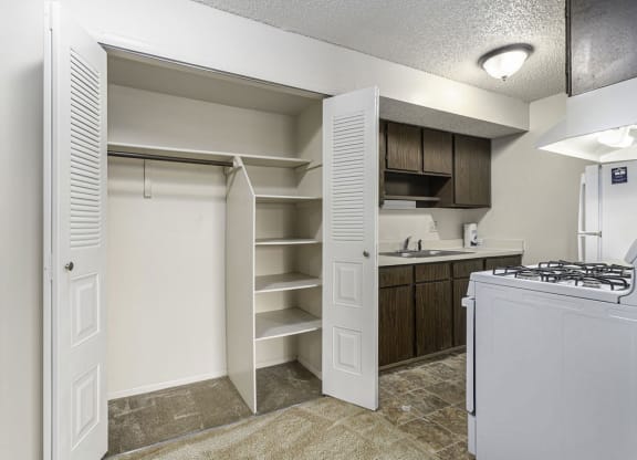 a kitchen with a closet and a stove and a sink at Madeira Apartments, Kalamazoo, 49001