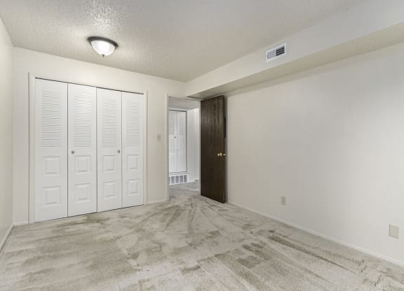 Bedroom with doors to a closet at Madeira Apartments, Kalamazoo, 49001