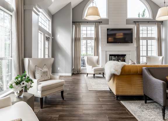A living room with a fireplace and a couch at Mallard Bay Apartments, Crown Point, Indiana