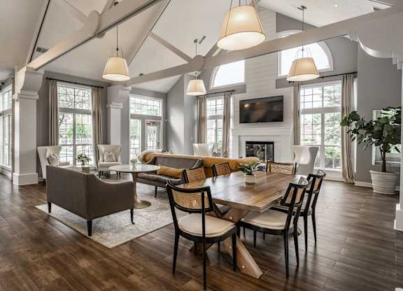 A large, well-lit dining room with a wooden table and chairs at Mallard Bay Apartments, Crown Point, Indiana