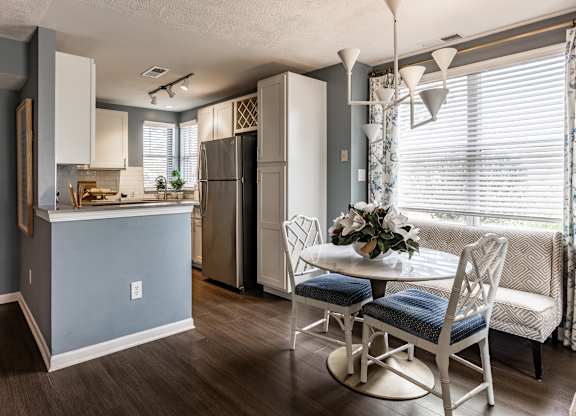 A kitchen with a table and chairs in front of a window at Mallard Bay Apartments, Crown Point, Indiana