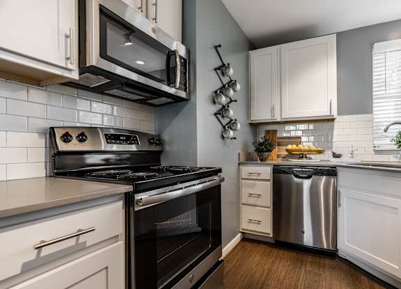 A modern kitchen with a stove, oven, and microwave at Mallard Bay Apartments, Crown Point, Indiana