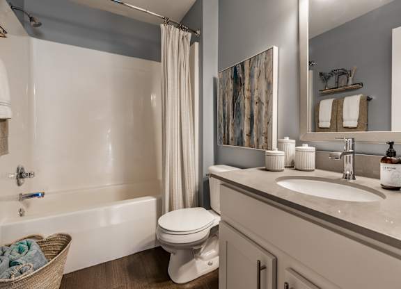 A bathroom with a white toilet, sink, and bathtub at Mallard Bay Apartments, Crown Point, Indiana