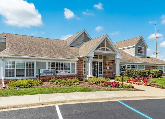 A building with a parking lot in front of it at Mallard Bay Apartments, Crown Point, Indiana