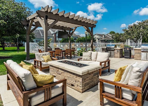 A patio with a fire pit and seating area at Mallard Bay Apartments, Crown Point, Indiana