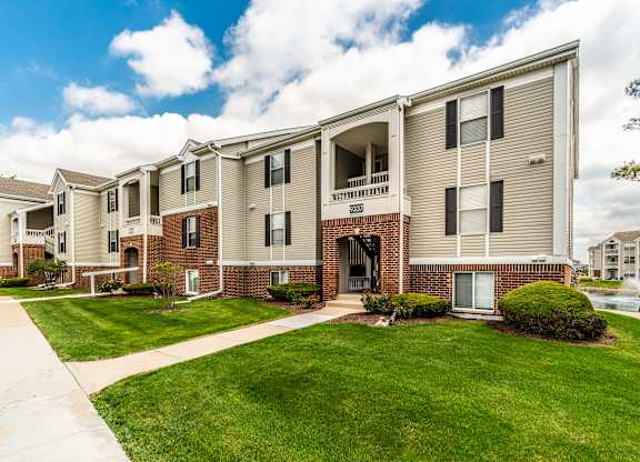 Apartment complex with a grassy front yard and a clear sky at Mallard Bay Apartments, Crown Point, Indiana