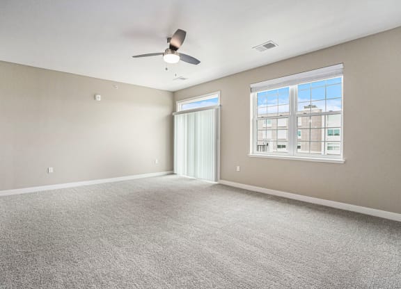 an empty bedroom with a ceiling fan at Meadowbrooke Apartment Homes, Michigan
