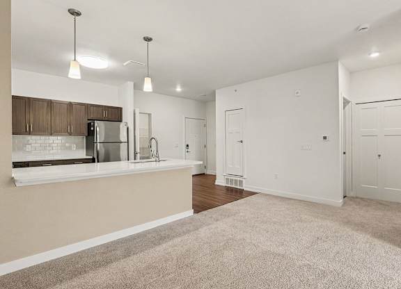 A kitchen and dining room with a breakfast bar at Meadowbrooke Apartment Homes in Grand Rapids, MI 49512