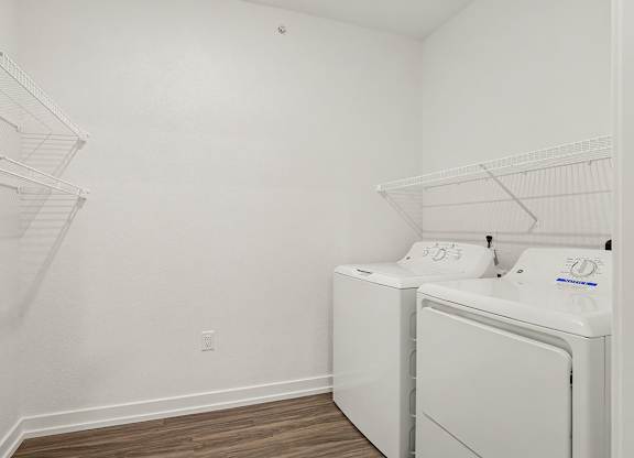 A laundry room with a washer and dryer at Meadowbrooke Apartment Homes in Grand Rapids, MI 49512