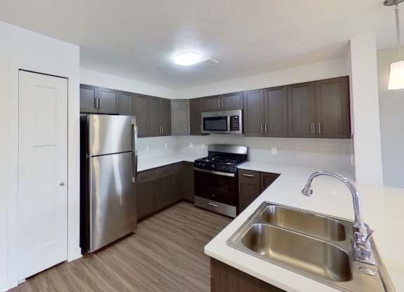 A kitchen with a stainless steel appliances at Meadowbrooke Apartment Homes in Kentwood, MI 49512