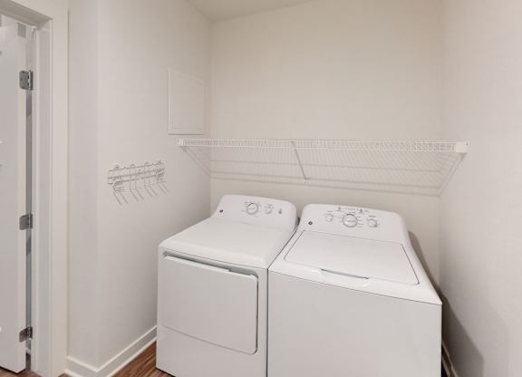 A laundry room with a full size washer and dryer at Meadowbrooke Apartment Homes in Kentwood, MI 49512
