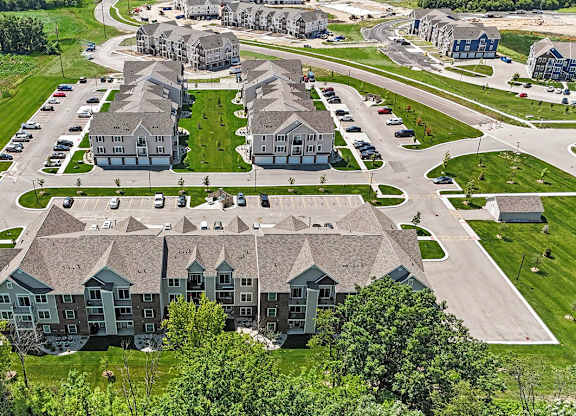 A bird's eye view of a residential area with modern apartment buildings at Meadowbrooke Apartment Homes in Grand Rapids, MI 49512
