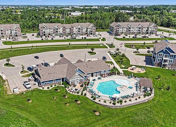 A bird's eye view of a residential area with a swimming pool at Meadowbrooke Apartment Homes in Grand Rapids, MI 49512