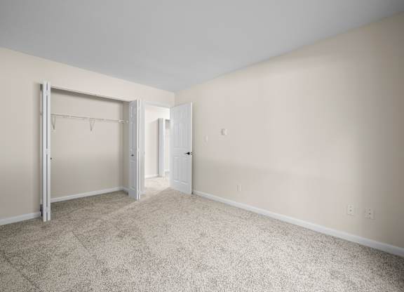 A room with a carpeted floor and two doorsk at Timberlane Apartments, Peoria, Illinois
