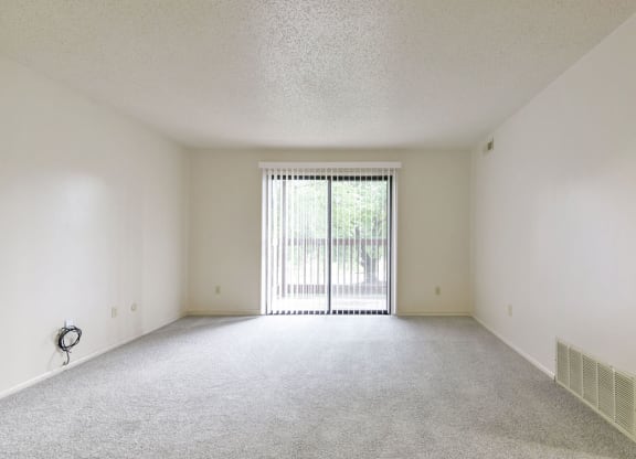 Living Room to Private Balcony at Old Monterey Apartments in Springfield, MO