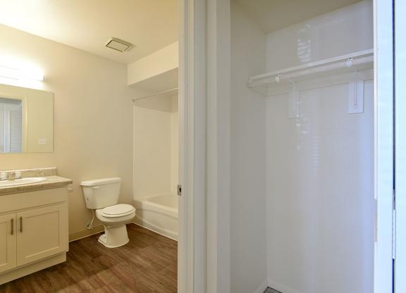 A white bathroom and a linen closet at Old Monterey Apartments in Springfield, MO