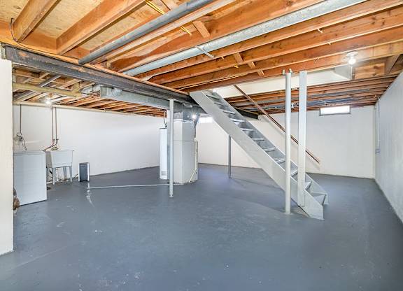 A basement with a washer and dryer along with lots of storage space at Mount Royal Townhomes, Michigan