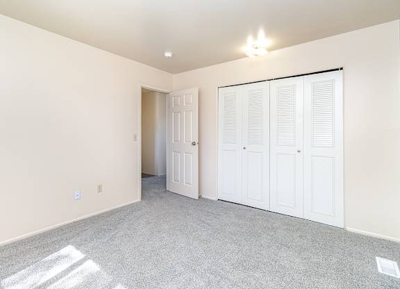 A bedroom with a large closet at Mount Royal Townhomes, Michigan