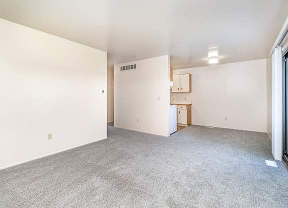 A spacious living to dining room with a kitchen around the corner at Mount Royal Townhomes, Michigan