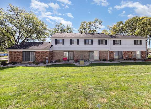 A brick exterior building rear view with patios at Mount Royal Townhomes in Kalamazoo, MI