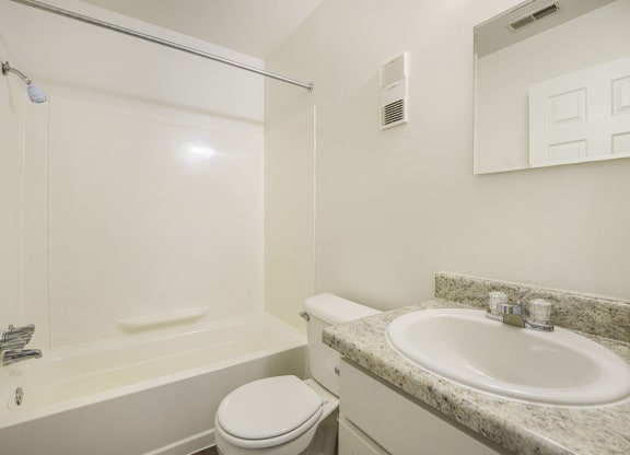 an upgraded bathroom with white cabinets at Newport Village Apartments, Portage, MI