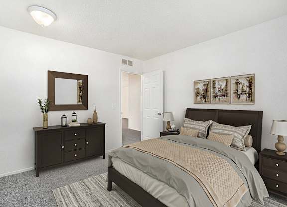 A bedroom with a bed, dresser, and mirror at Newport Village Apartments in Portage, MI