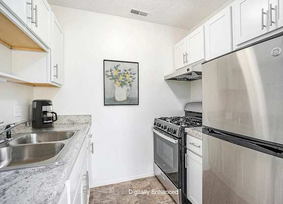 A kitchen with a stainless steel appliances at Newport Village Apartments, Portage, MI