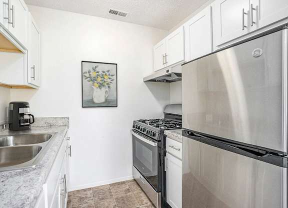 A kitchen with a stainless steel appliances at Newport Village Apartments, Portage, MI