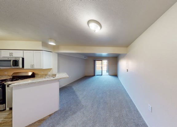a renovated kitchen and a large living room at North Pointe Apartments in Elkhart, IN