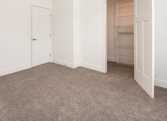 Bedroom with carpet and a walk-in closet at North Pointe Apartments in Elkhart, IN