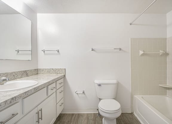 an upgraded bathroom with a sink toilet and a bath tub at North Pointe Apartments in Elkhart, IN