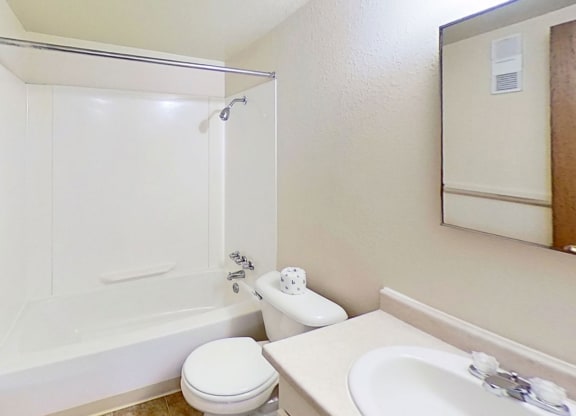 master bathroom with a sink toilet and a bathtub/shower combination at Normandy Village Apartments, Michigan City, 46360