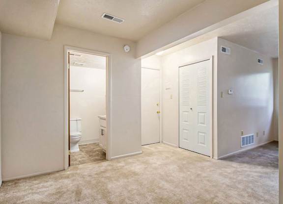 An entryway with a closet and a door to a full bathroom at Normandy Village Apartments, Michigan City